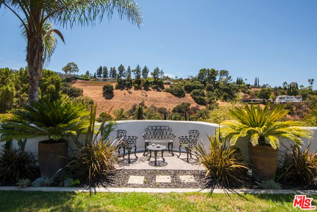 a view of swimming pool with a garden and seating area