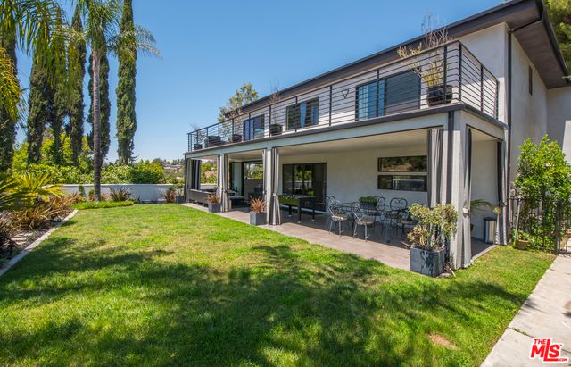 a front view of a house with a yard table and chairs