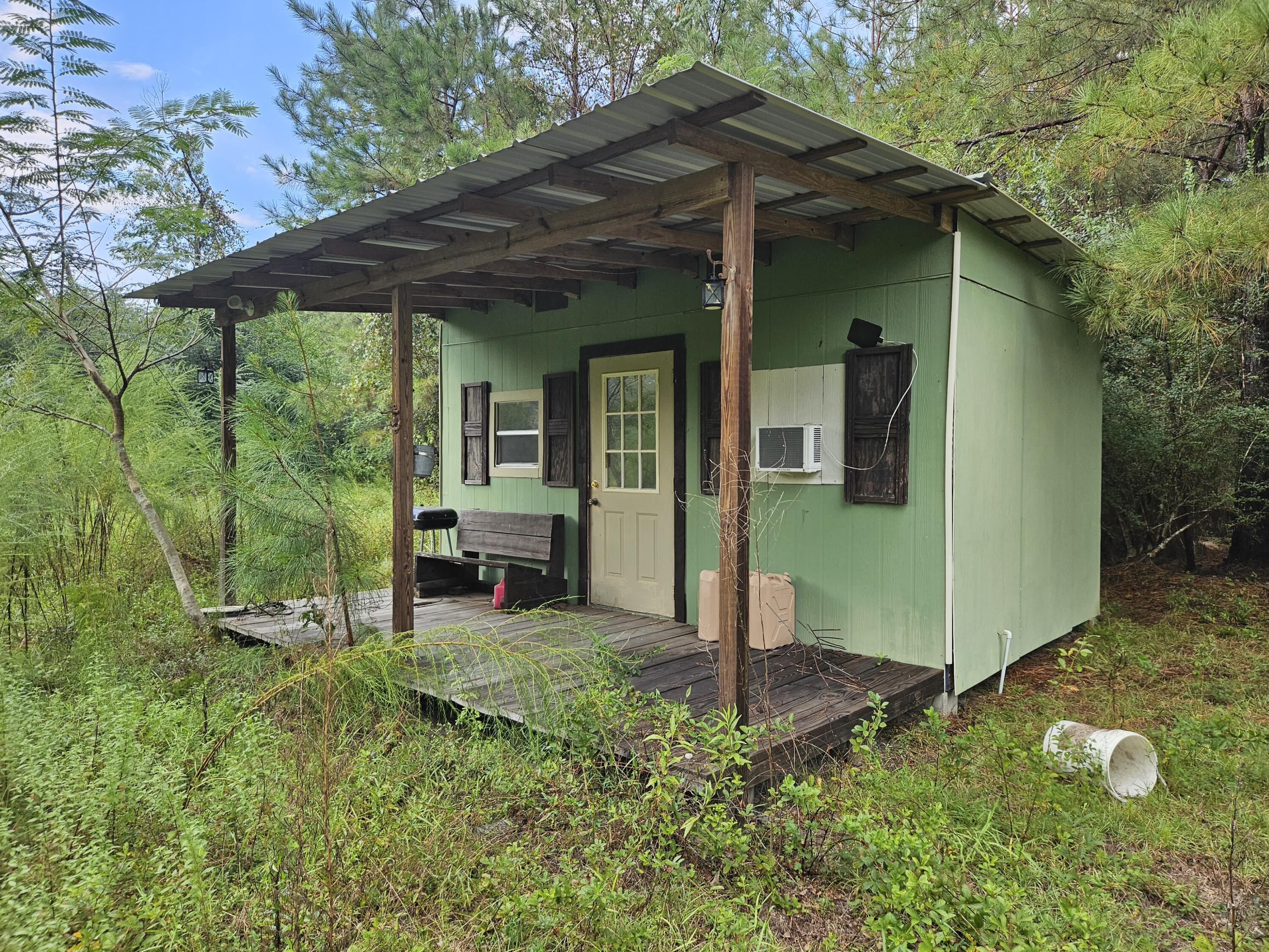 8330 Davis Road Laurel Hill, FL 32567 - Photo 3 of 7 a view of a house with backyard