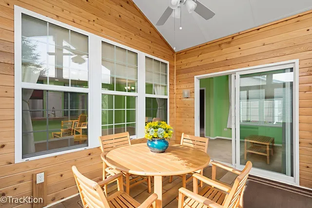 a view of a dining room with a table and chairs