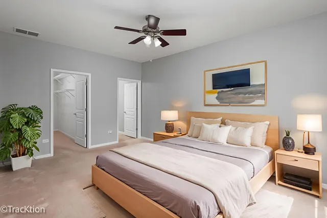 a bedroom with a bed and a ceiling fan