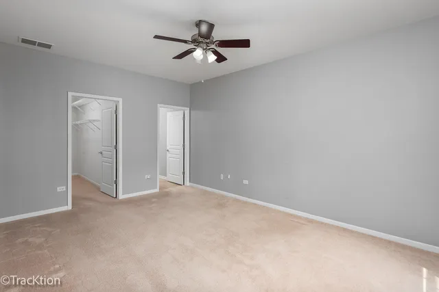 a view of a livingroom with a ceiling fan and window