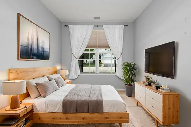 a bedroom with a bed and a flat screen tv