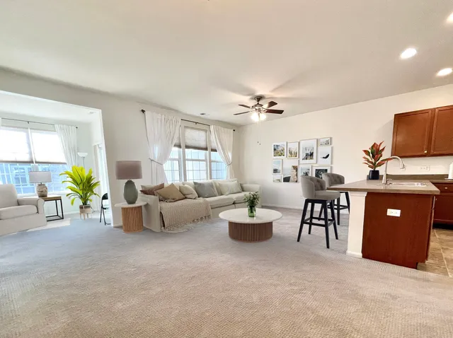 a living room with furniture and chandelier