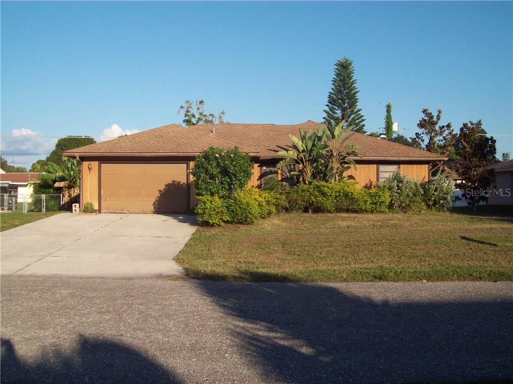 2655 Serpula Road Venice, FL 34293 - Photo 1 of 1 a front view of a house with a yard and garage