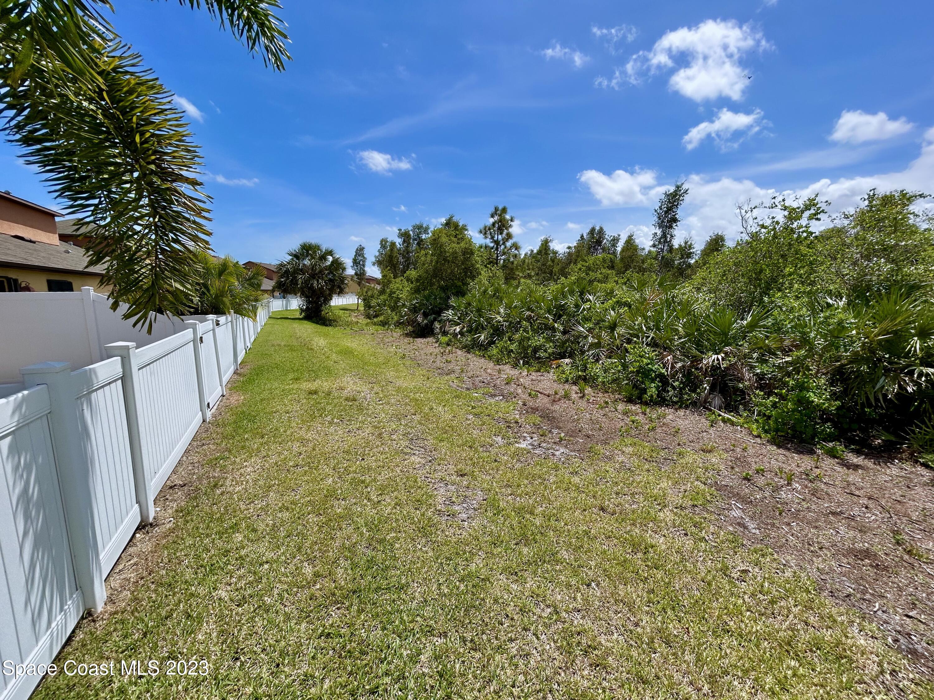 1160 Luminary Circle, Unit 105 Melbourne, FL 32901 - Photo 11 of 35 a view of a pathway with a yard