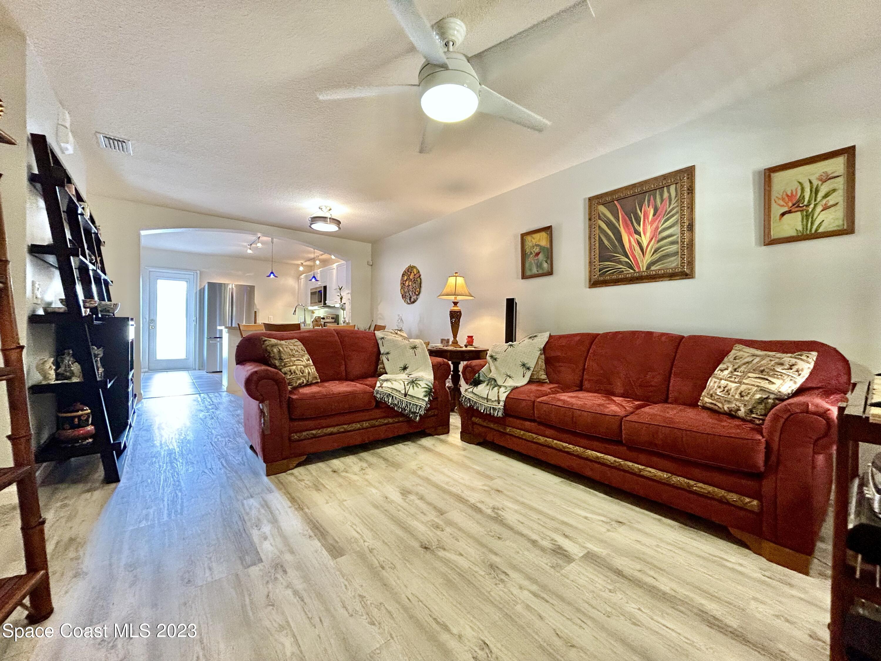 1160 Luminary Circle, Unit 105 Melbourne, FL 32901 - Photo 12 of 35 a living room with furniture and a wooden floor