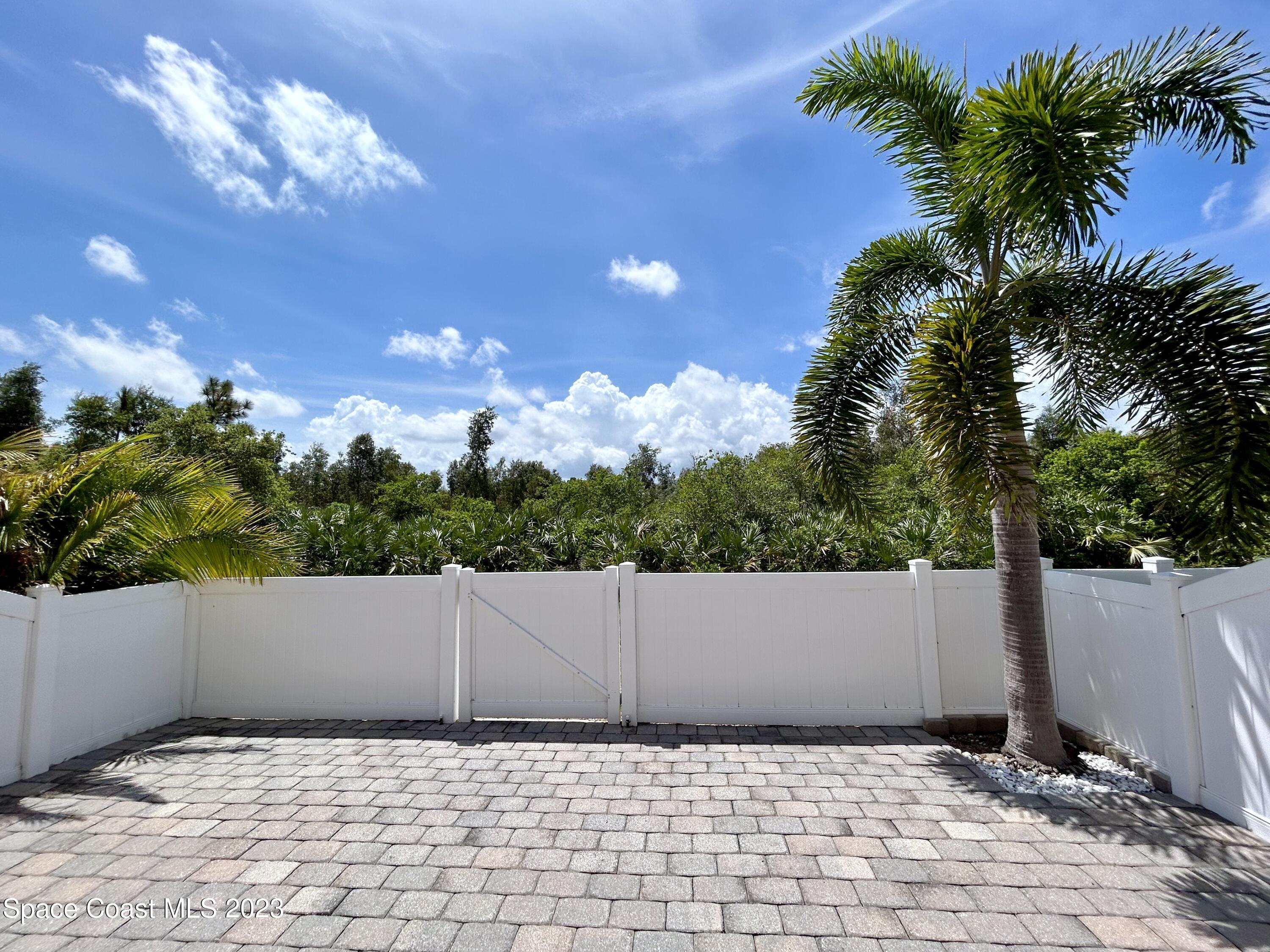 1160 Luminary Circle, Unit 105 Melbourne, FL 32901 - Photo 8 of 35 a view of potted plants and a yard