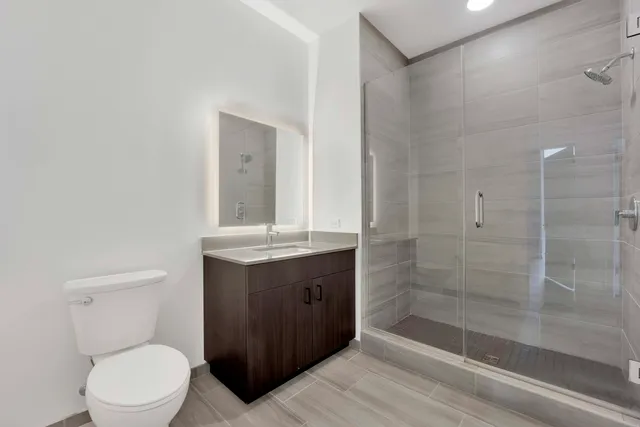 a bathroom with a toilet a sink and shower