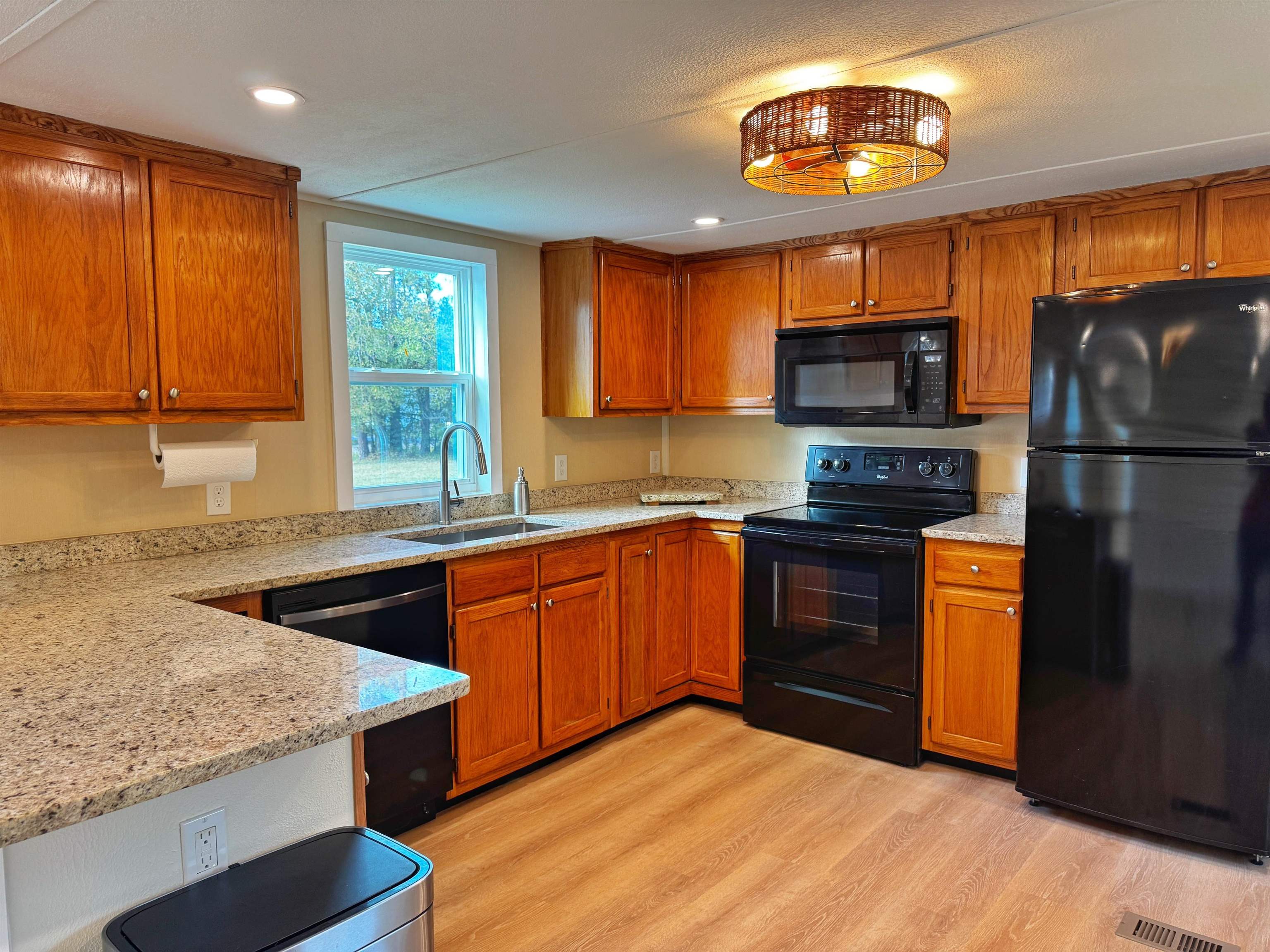4062 Quail Drive St. Augustine, FL 32084 - Photo 13 of 39 a kitchen with stainless steel appliances granite countertop a stove a sink dishwasher a refrigerator and a microwave oven with wooden floor