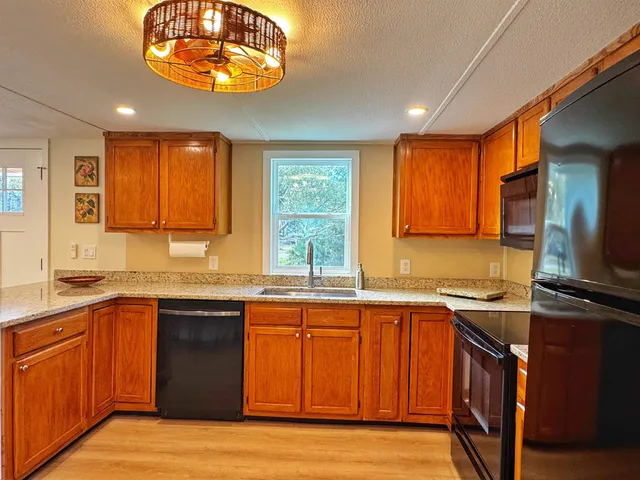 a kitchen with stainless steel appliances granite countertop a sink and stove top oven