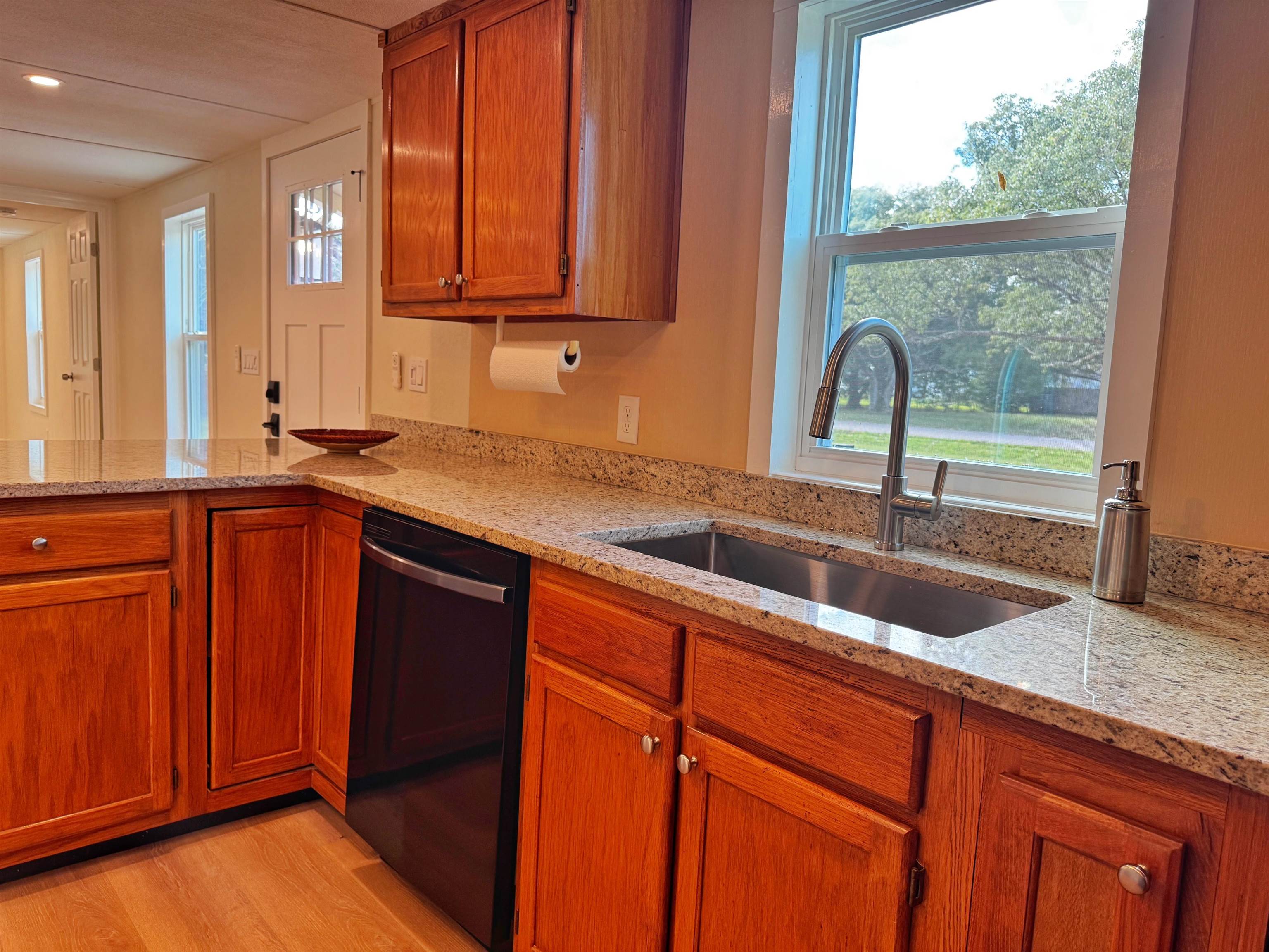 4062 Quail Drive St. Augustine, FL 32084 - Photo 16 of 39 a kitchen with stainless steel appliances granite countertop a sink a counter space and cabinets