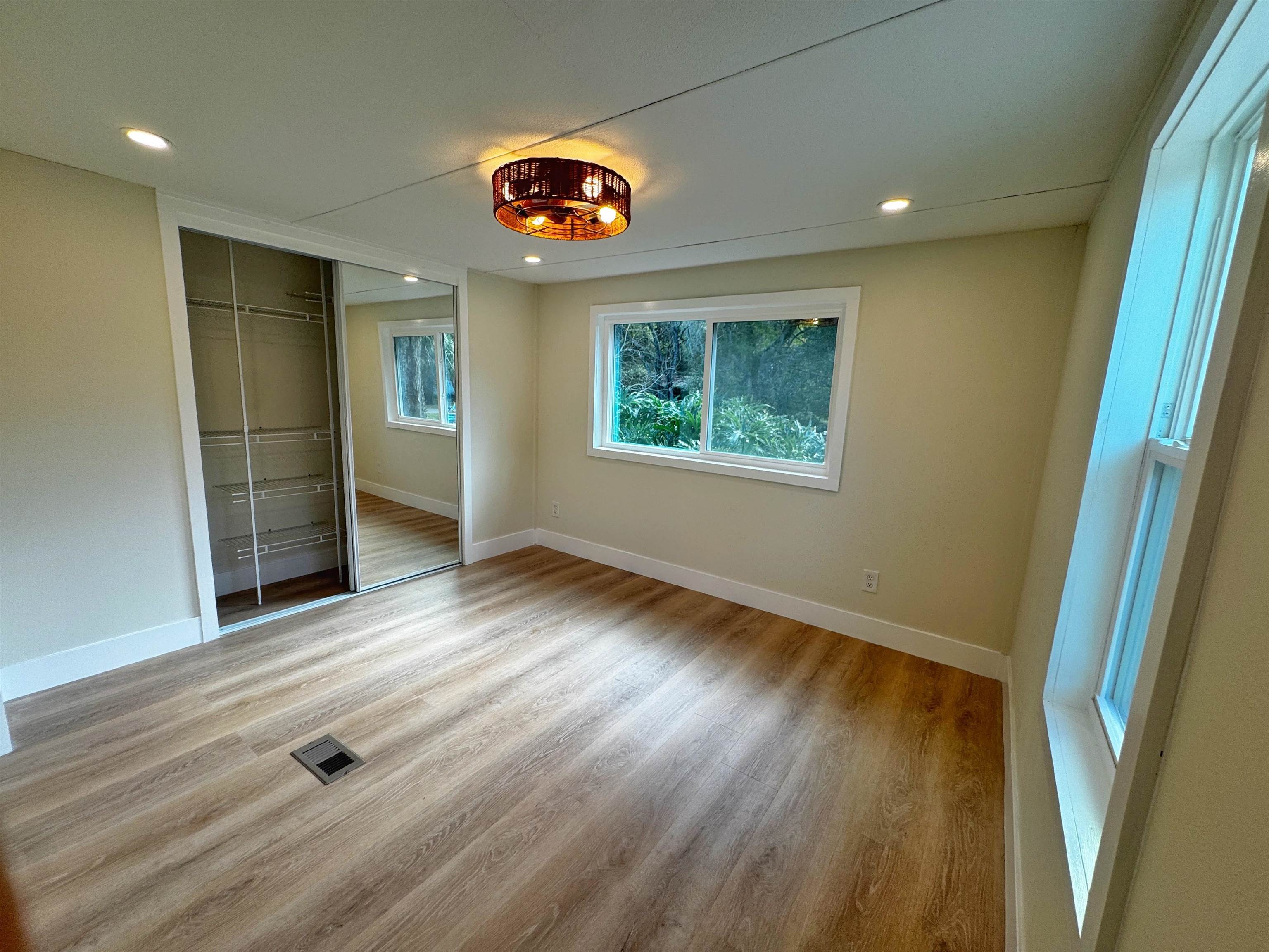 4062 Quail Drive St. Augustine, FL 32084 - Photo 17 of 39 an empty room with wooden floor and windows