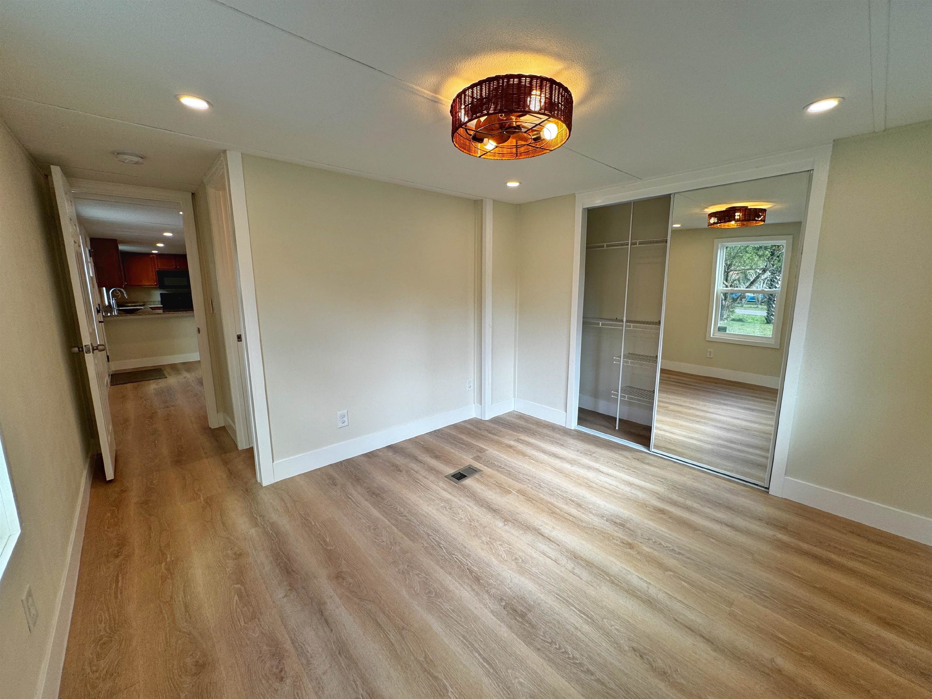 4062 Quail Drive St. Augustine, FL 32084 - Photo 19 of 39 an empty room with wooden floor and windows