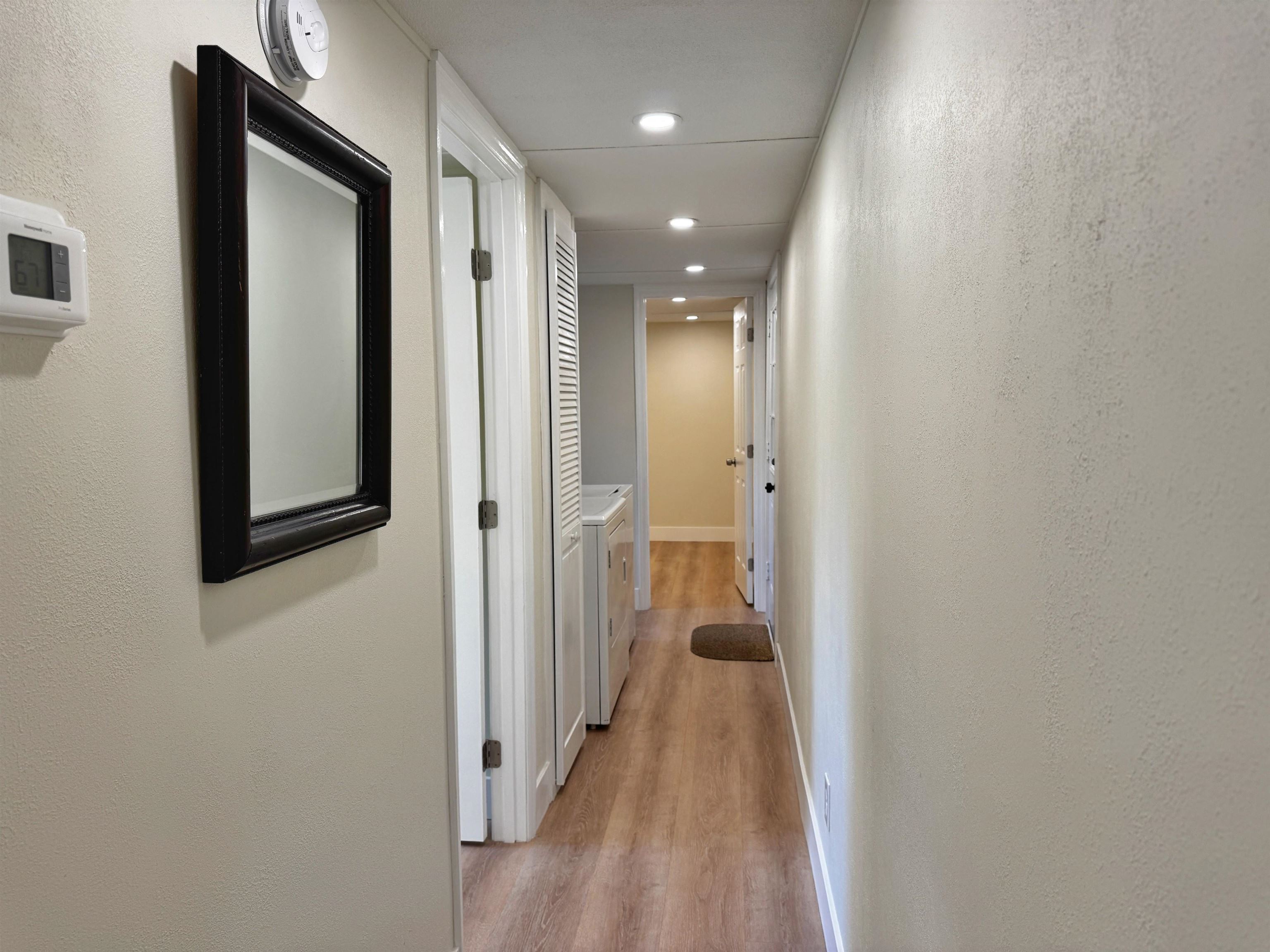 4062 Quail Drive St. Augustine, FL 32084 - Photo 23 of 39 a view of a hallway with wooden floor and a bathroom