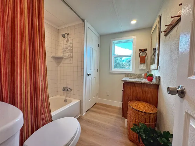 a bathroom with a toilet a sink and bathtub