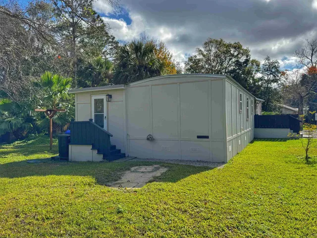 a view of a house with a backyard