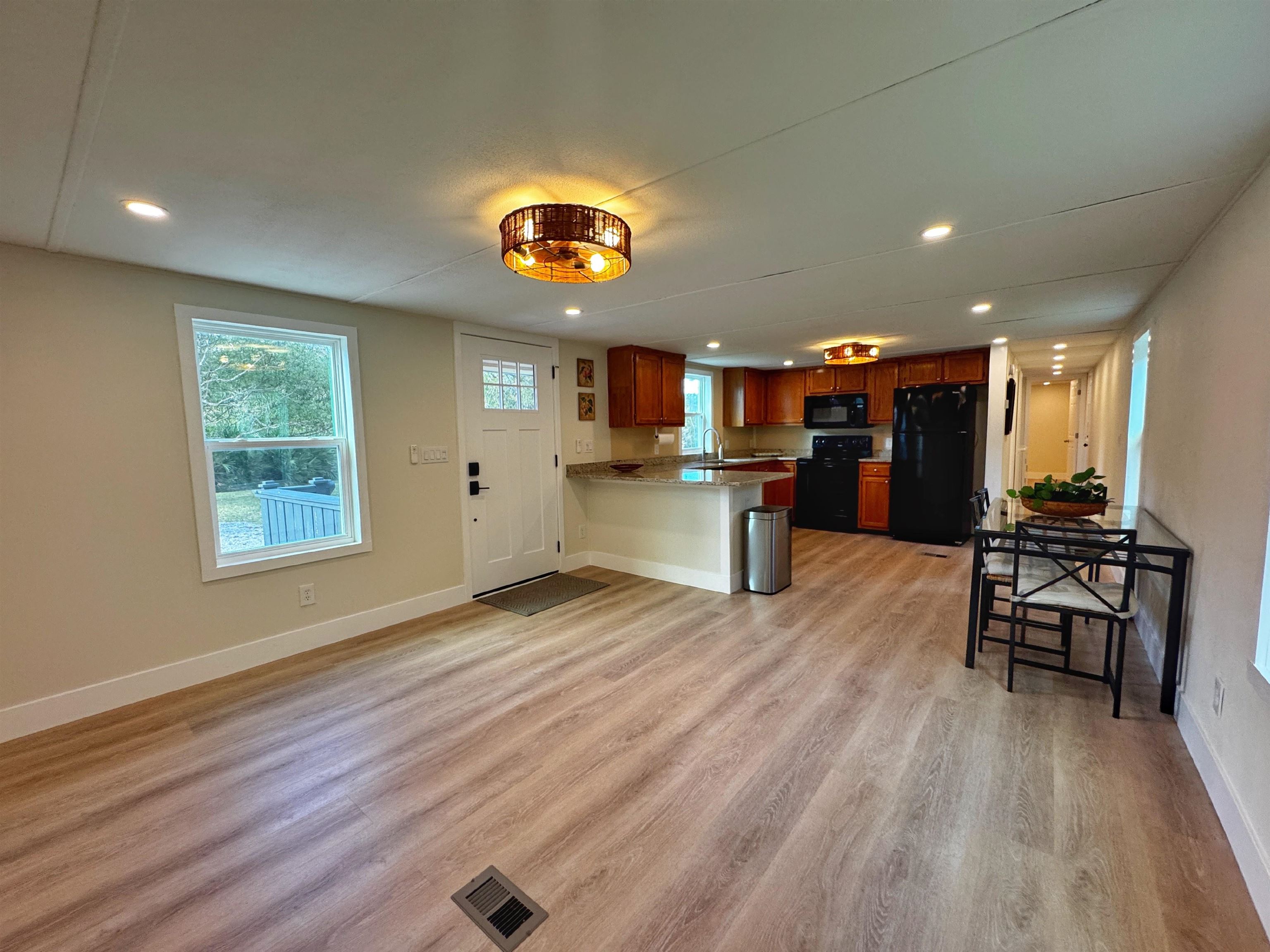 4062 Quail Drive St. Augustine, FL 32084 - Photo 7 of 39 an open kitchen view with a stove and wooden floor