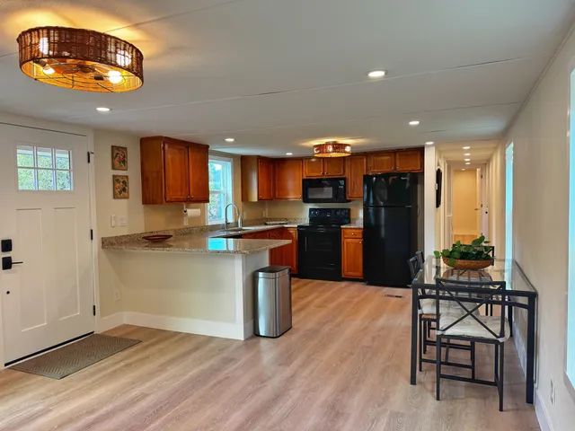 a kitchen with stainless steel appliances granite countertop a refrigerator and a stove top oven