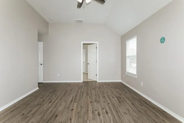 a spacious bathroom with a tub sink shower and mirror