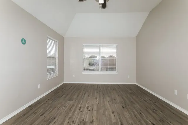 a front view of a house with a garden and yard