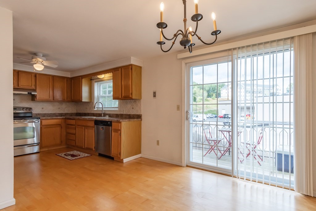 3 East Ridge Road, Unit 3 Merrimack, NH 03054 - Photo 7 of 17 a kitchen with granite countertop a stove a sink and a granite counter top