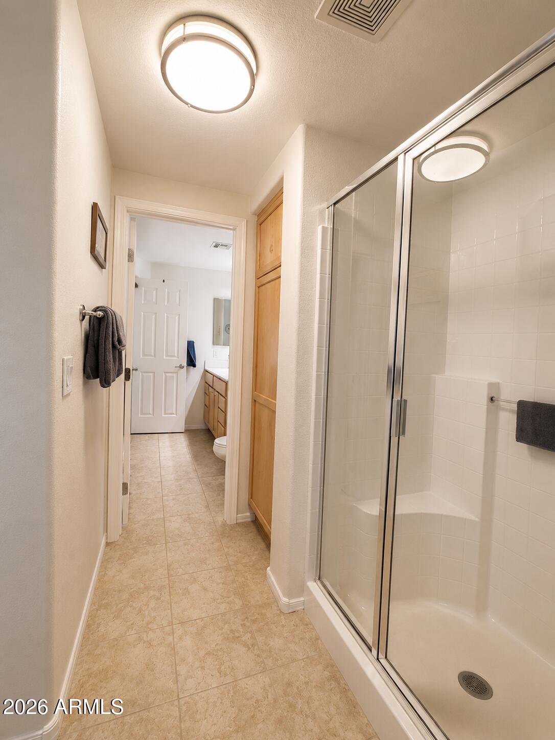 2150 West Alameda Road, Unit 1020 Phoenix, AZ 85085 - Photo 25 of 35 a view of a bathroom with a tub and shower