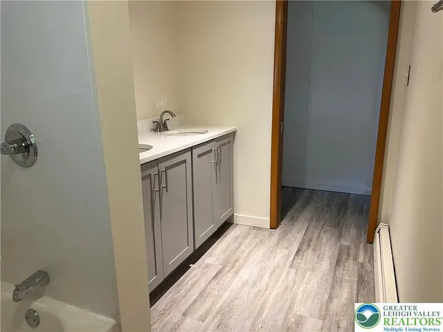 a bathroom with a sink and mirror