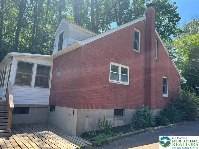 a brick building with a yard in front of it
