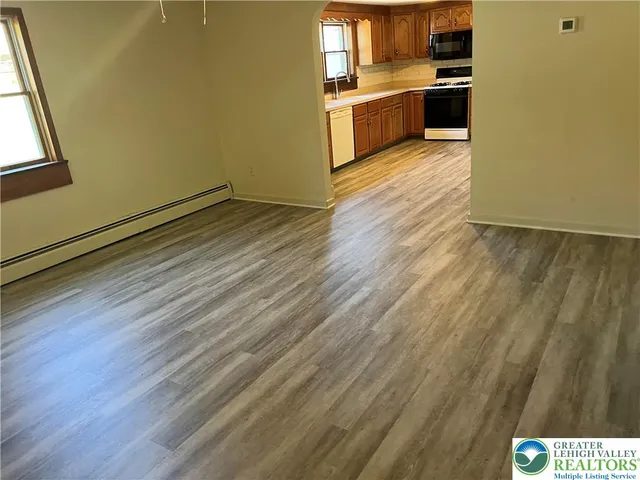 a kitchen with granite countertop a sink cabinets and stainless steel appliances