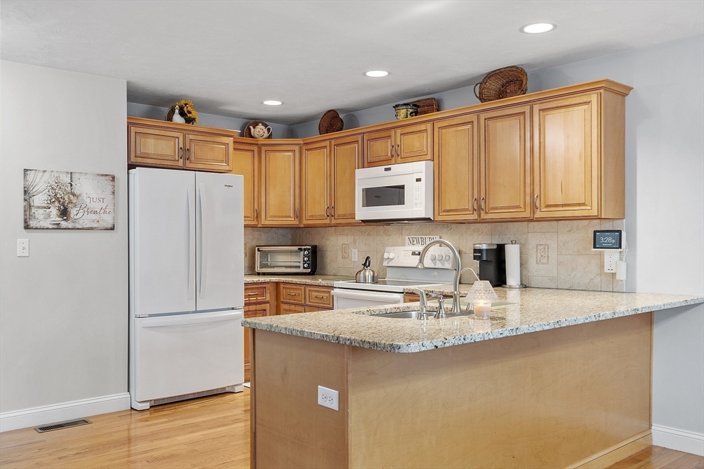 191 Scotland Road, Unit 2 Newbury, MA 01951 - Photo 8 of 37 a kitchen with stainless steel appliances granite countertop a refrigerator sink and microwave