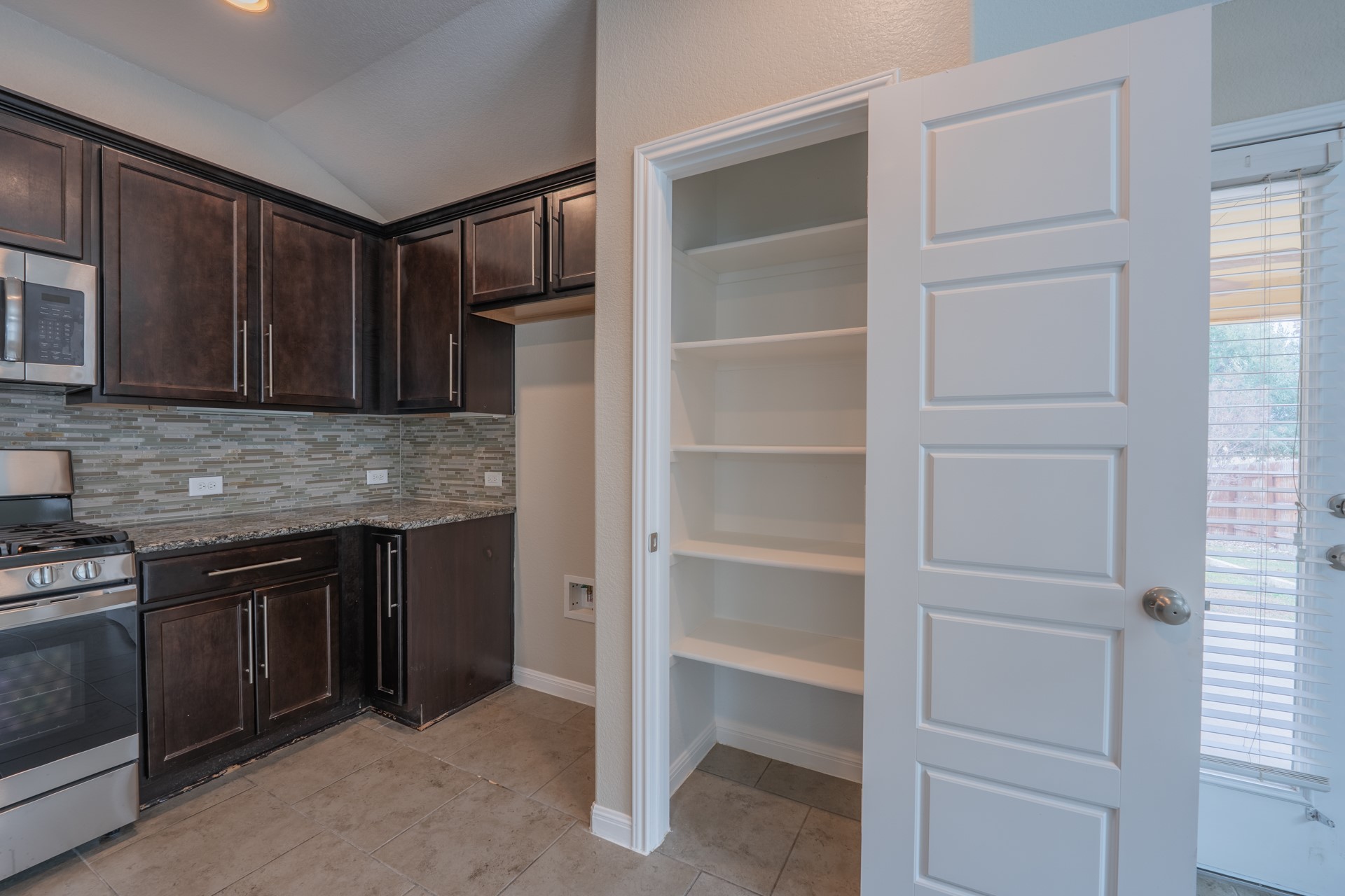 624 Joppa Road Leander, TX 78641 - Photo 12 of 36 a kitchen with cabinets and a refrigerator