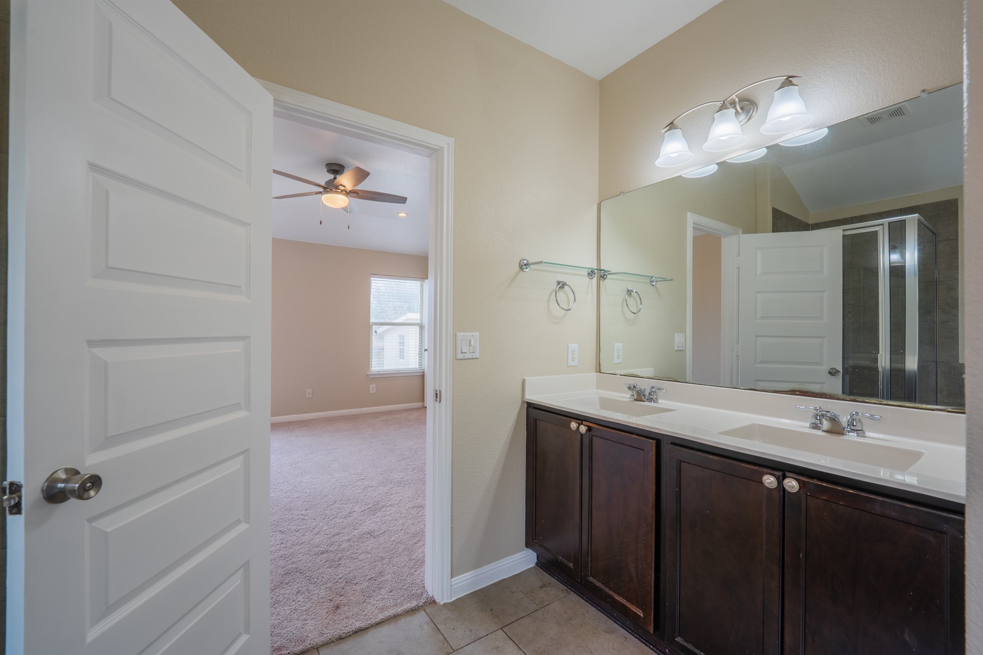624 Joppa Road Leander, TX 78641 - Photo 19 of 36 a bathroom with a double vanity sink and a mirror