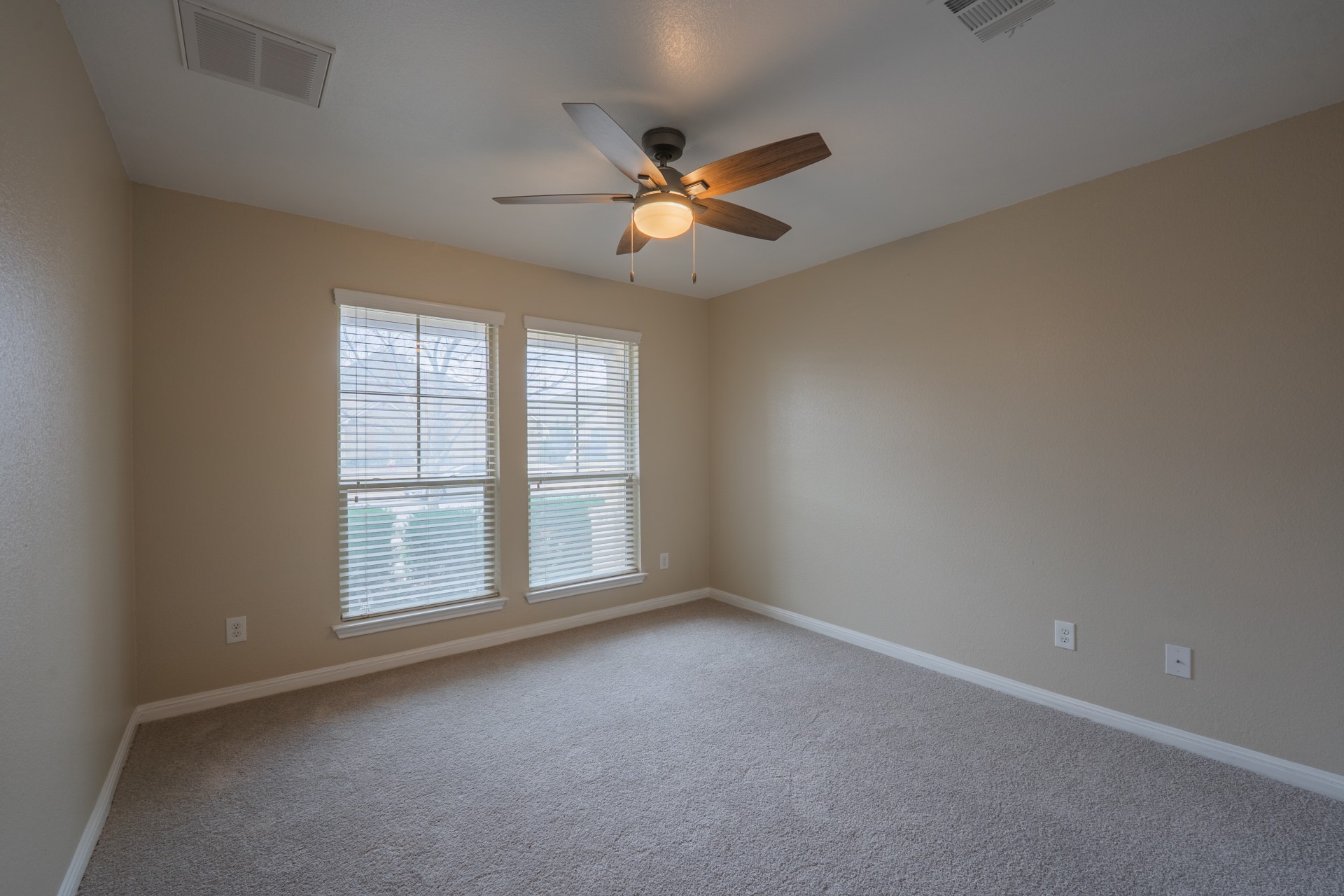 624 Joppa Road Leander, TX 78641 - Photo 23 of 36 an empty room with windows and fan