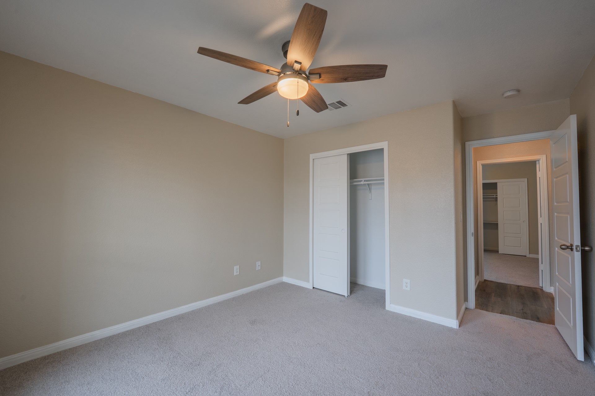624 Joppa Road Leander, TX 78641 - Photo 24 of 36 an empty room with closet and a chandelier fan