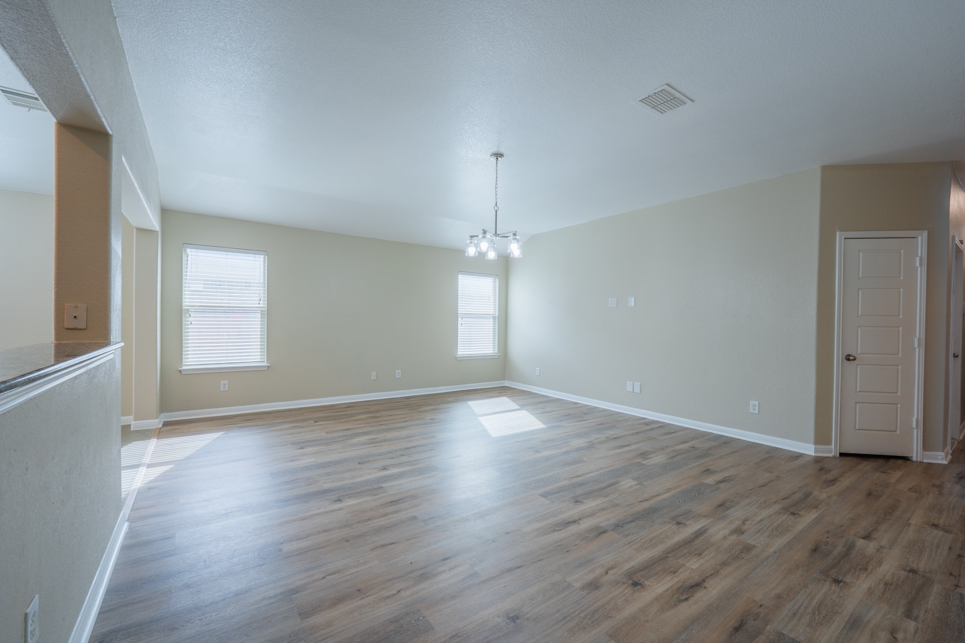 624 Joppa Road Leander, TX 78641 - Photo 4 of 36 an empty room with wooden floor and windows