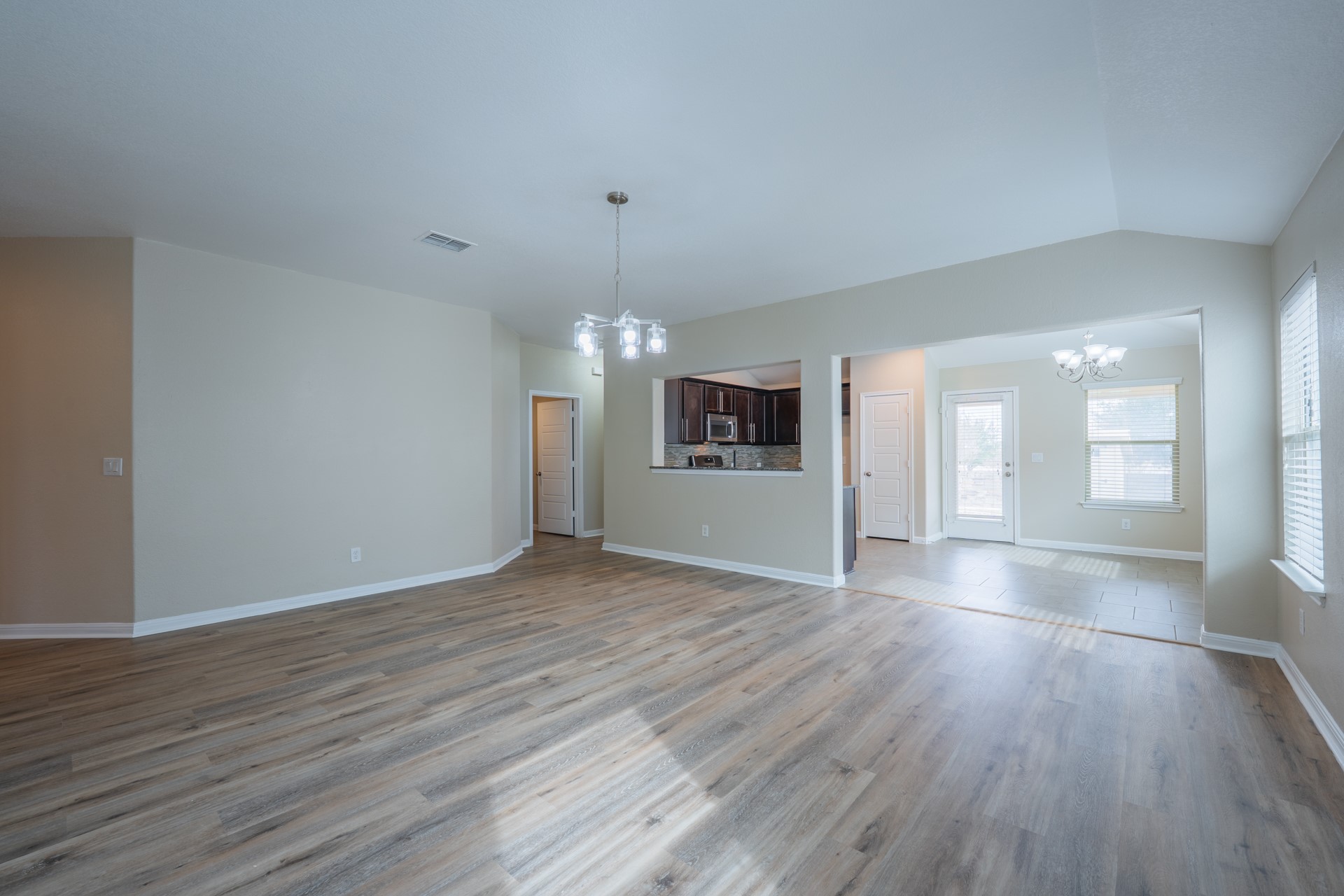 624 Joppa Road Leander, TX 78641 - Photo 6 of 36 a view of an empty room with window and wooden floor
