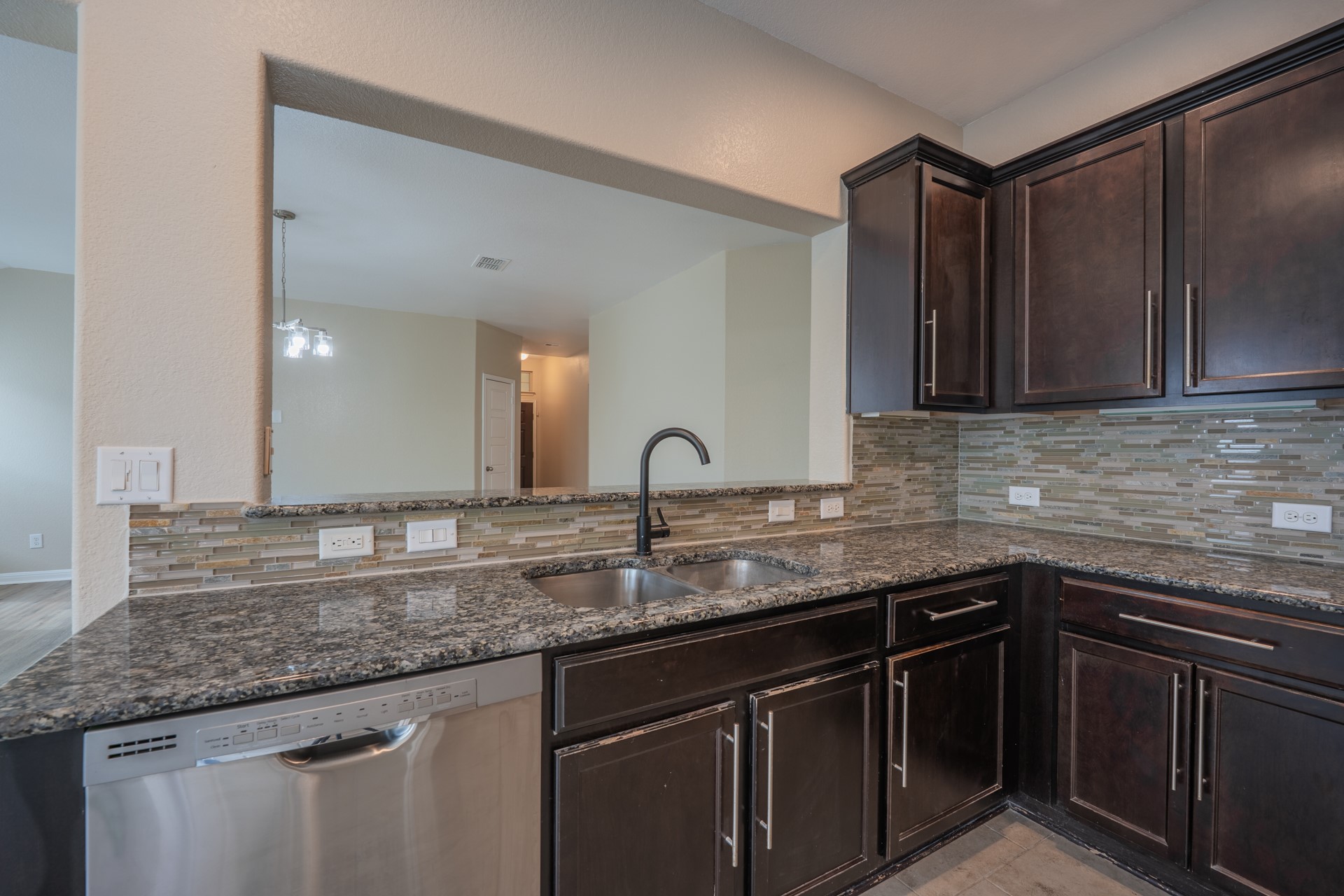 624 Joppa Road Leander, TX 78641 - Photo 9 of 36 a kitchen with granite countertop a sink and cabinets