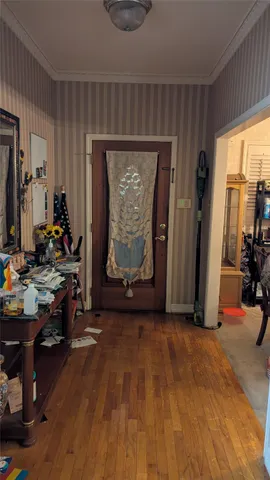 a room with lots of books and a large window