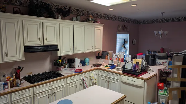 a kitchen with cabinets a sink and appliances