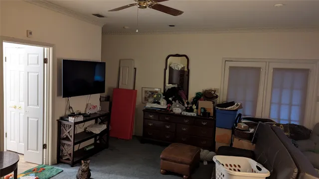 a view of a backyard with table and chairs potted plants and wooden fence