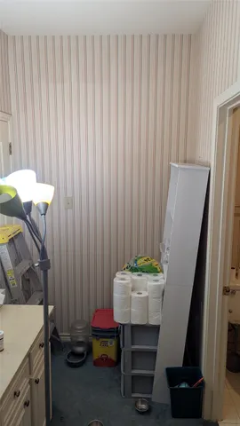 a room with a table chair and a refrigerator