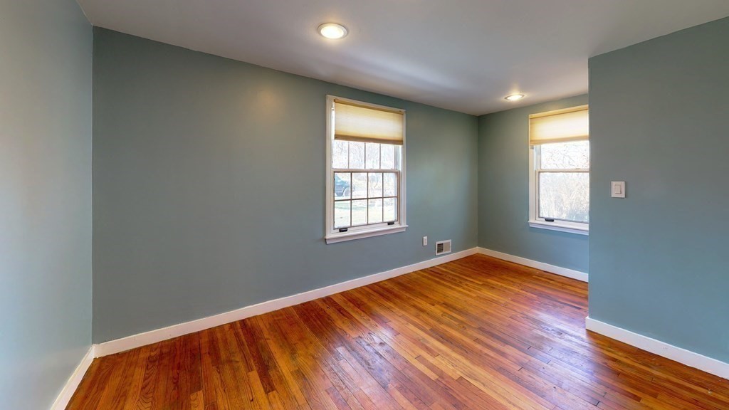 6 Egypt Beach Road Scituate, MA 02066 - Photo 25 of 29 an empty room with wooden floor and windows