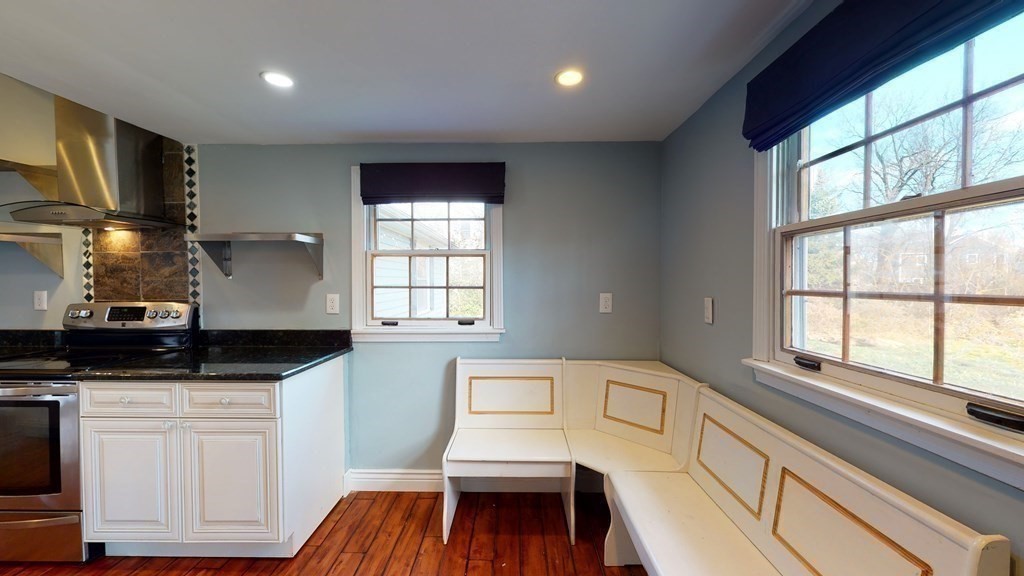 6 Egypt Beach Road Scituate, MA 02066 - Photo 5 of 29 a kitchen with granite countertop a stove a sink and white cabinets with wooden floor