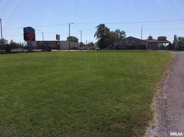 a view of grassy field with mountain