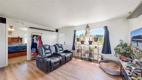 a living room with furniture and wooden floor