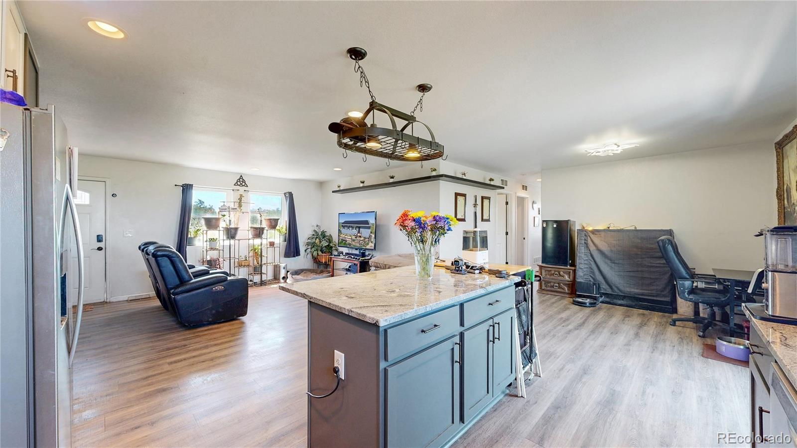 40291 Gold Nugget Road Deer Trail, CO 80105 - Photo 14 of 47 a living room with furniture and a wooden floor
