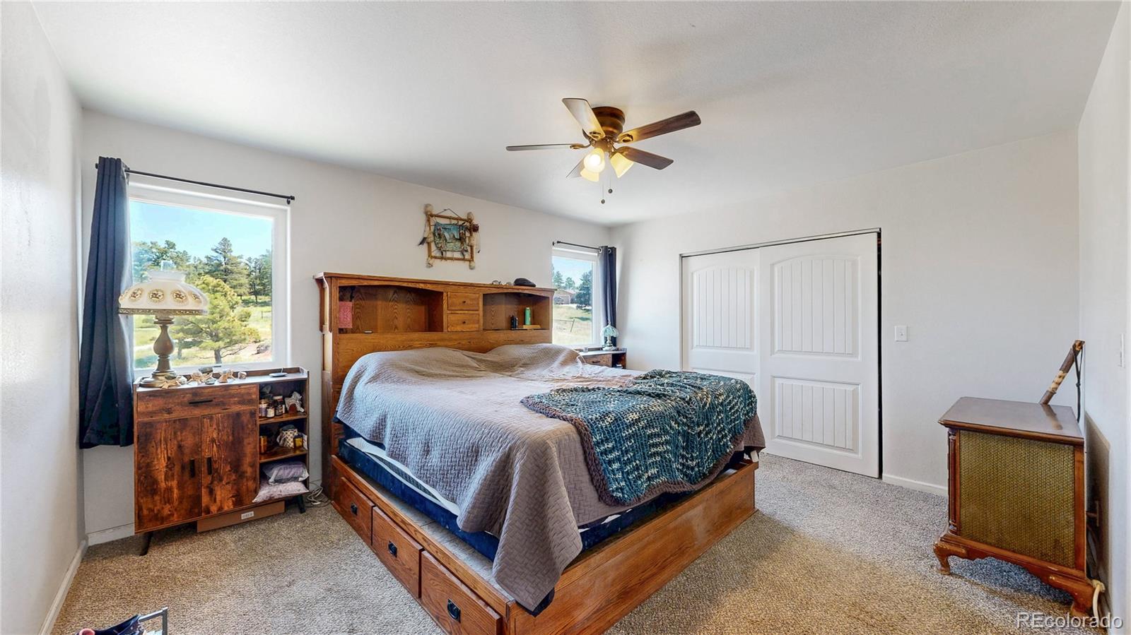 40291 Gold Nugget Road Deer Trail, CO 80105 - Photo 22 of 47 a bedroom with a bed a window and a couch