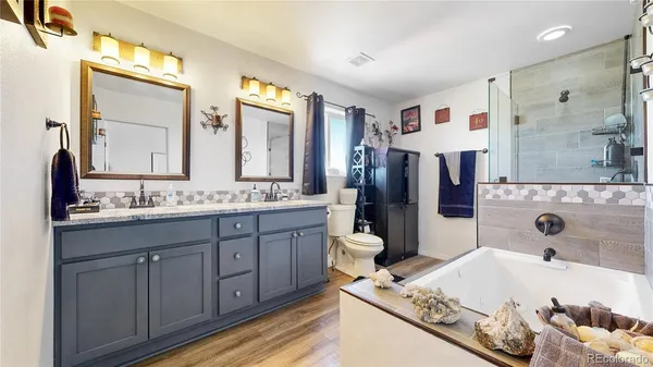 a bathroom with a tub sink and mirror