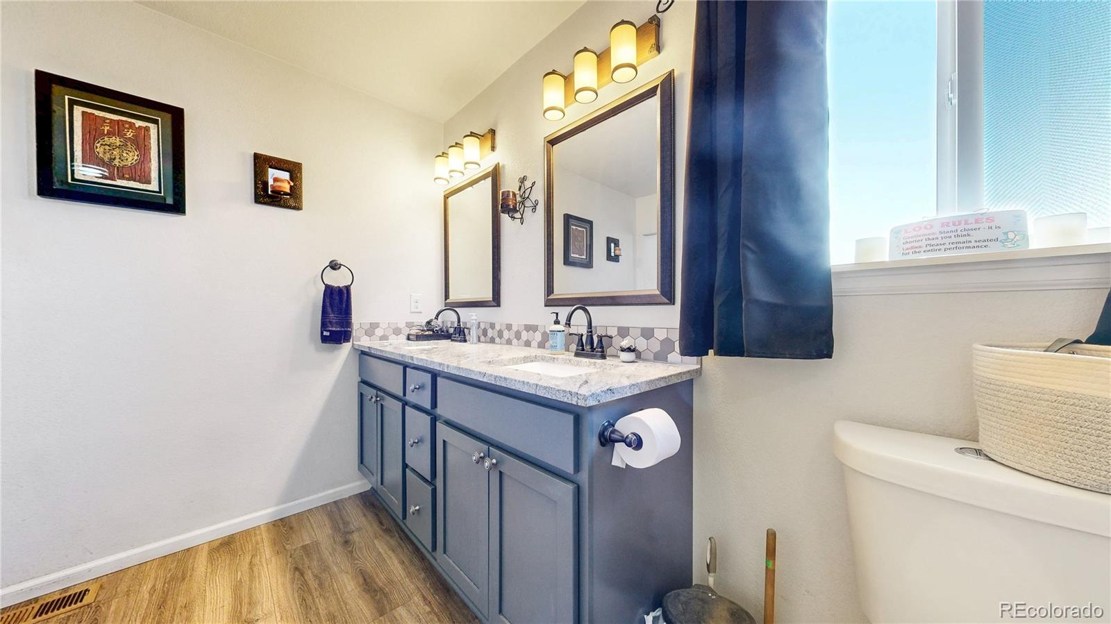 40291 Gold Nugget Road Deer Trail, CO 80105 - Photo 26 of 47 a bathroom with a sink a toilet and a mirror